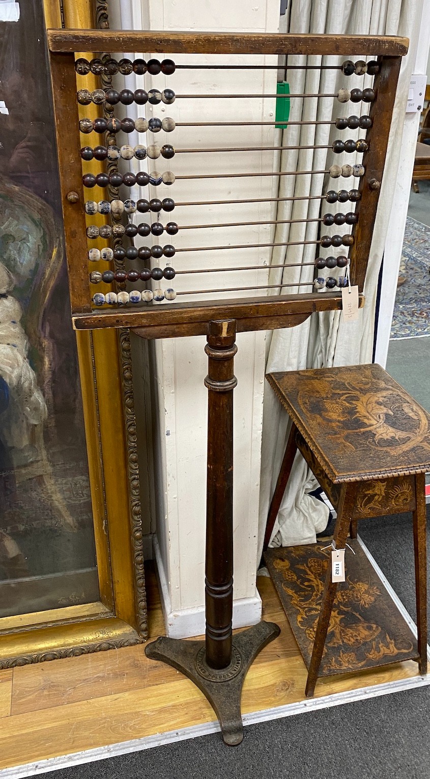 An early 20th century Educational Supply Co. beech classroom abacus on cast iron triangular platform, height 153cm
